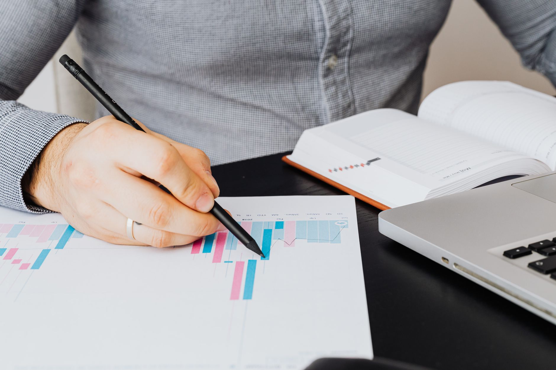 a person circling AI tool rankings on a printed spreadsheet