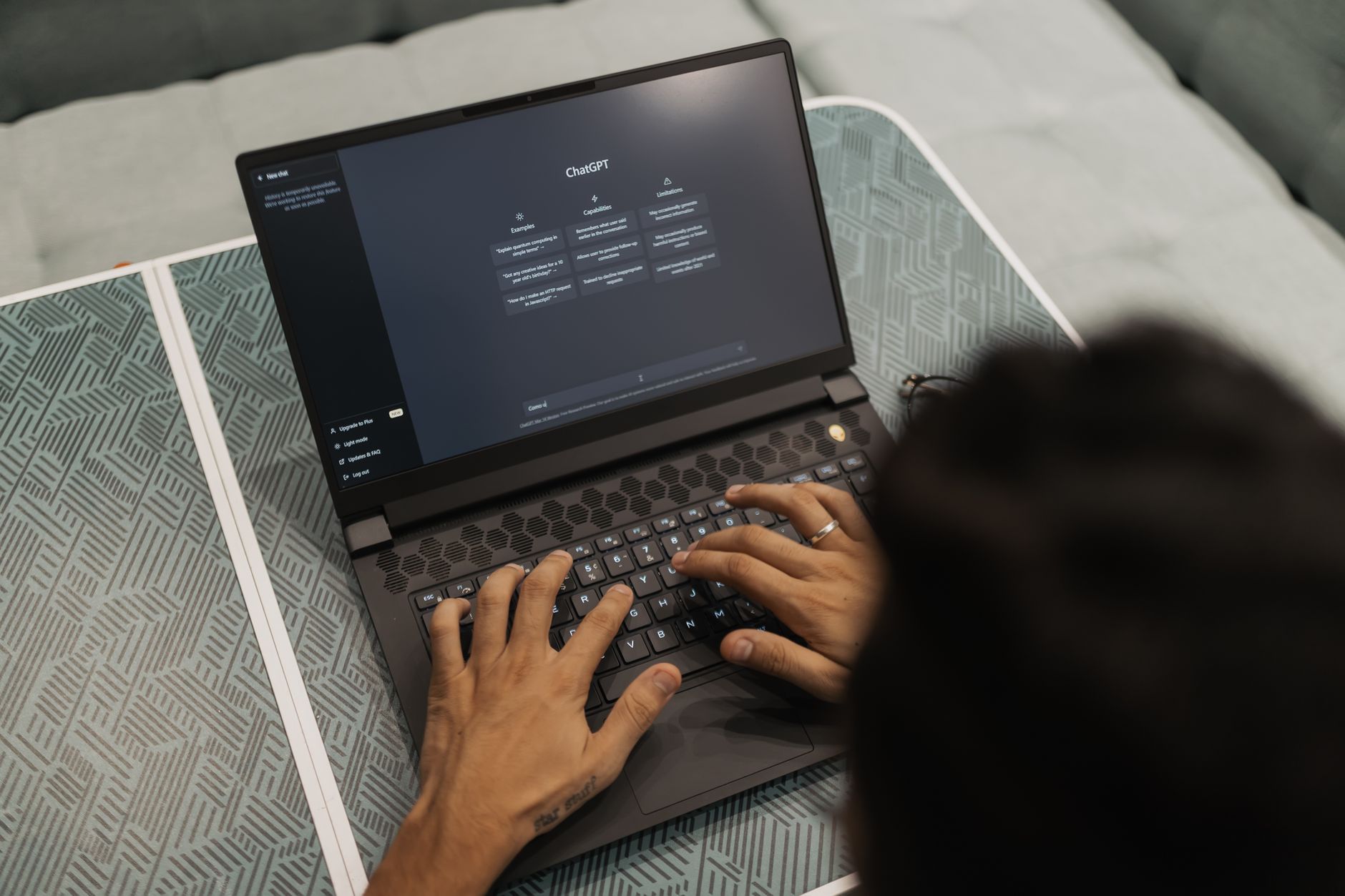 Person comparing two ChatGPT subscription plans on a laptop screen